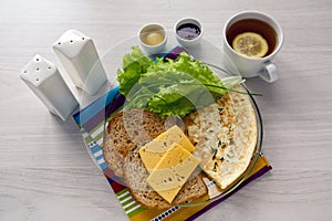 Breakfast with scrambled eggs on a transparent plate toast