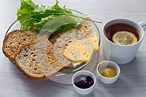 Breakfast with scrambled eggs on a transparent plate toast