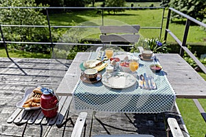 Breakfast served with coffee, orange juice, croissants, cheese and fruits on the village terrace. Balanced diet