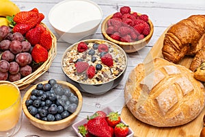 Breakfast Served in the morning with Butter croissant and corn flakes Whole grains and raisins with milk in cups and Strawberry,