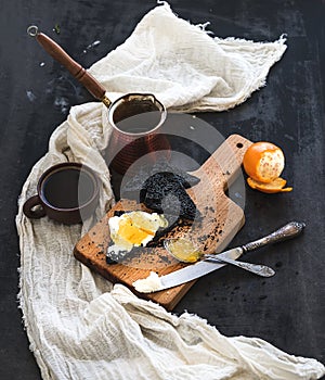 Breakfast set. Black bread toasts with tangerine