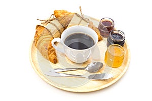 Breakfast set have a tray of coffee, croissant, jams