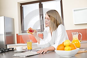 Breakfast - Smiling woman reading newspaper