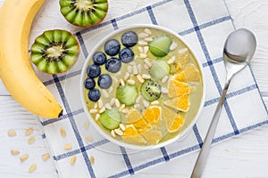 Breakfast smoothie bowl with matcha green tea, kiwi and banana