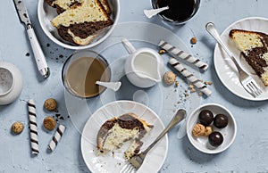 Breakfast or snack table - coffee, cookies, candy, cake, cream on a blue background