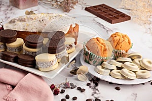 Breakfast and snack with tea and coffee with cornstarch, chocolate alfajores, mini donuts, muffins