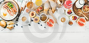 Breakfast snacks and drinks set on white wooden background