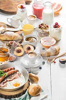 Breakfast snacks and drinks set on white wooden background