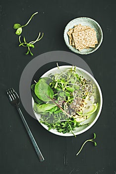 Breakfast with spinach, arugula, avocado, seeds and sprouts, top view
