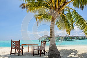 Breakfast spot with table and chairs on the tropical beach