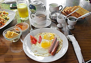 Breakfast in Sri Lanka. Scrambled eggs with sausages and coffee