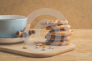 breakfast with stacked chip cookies with nuts and coffee cup/ breakfast with stacked chip cookies with nuts and coffee cup on a