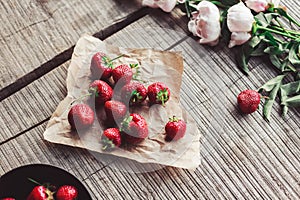 Breakfast with strawberries and flowers on the rustic table. Healthy breakfast, Clean eating, vegan food concept.