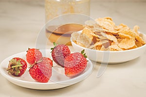 Breakfast with strawberry, flakes and honey/healthy concept: breakfast with strawberry, flakes and honey on a white marble