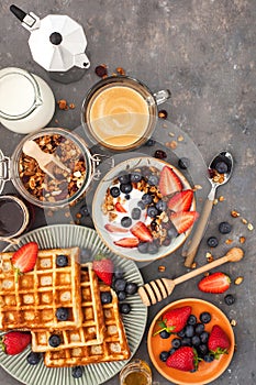 Breakfast table with cereal granola, milk, fresh berries, coffee