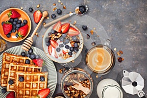 Breakfast table with cereal granola, milk, fresh berries, coffee