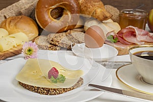 Breakfast table with Cheese bread, coffee, egg, ham and jam