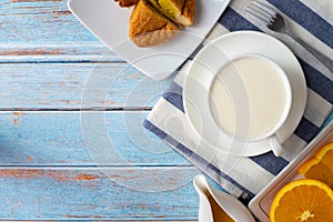 Breakfast table with Milk and sliced orange