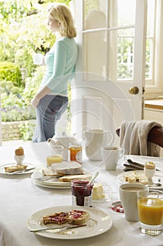 Breakfast Table With Woman In Background