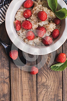 Breakfast. Tasty oatmeal with berries. Healthy breakfast ingredients.