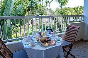 breakfast on their balcony of an appartment luxury hotel condo in Mauritius