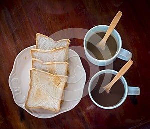 Breakfast time with two coffee and bread