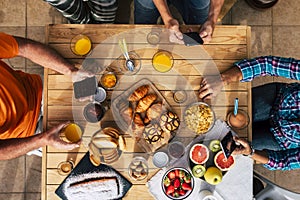 Breakfast time in vertical top view with family of friends eating together - technology mobile internet social network addiction