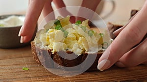 Breakfast toast with cream cheese, scrambled eggs and scallions