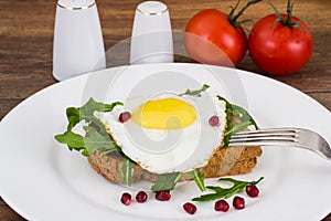 Breakfast toast with fried egg and arugula