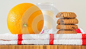 Breakfast tray: cookies, milk and orange