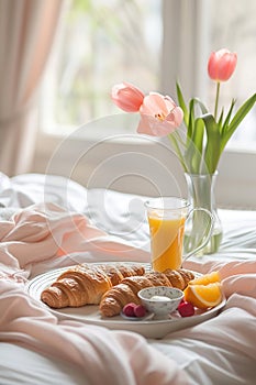 Breakfast tray with croissants and juice on a bed., Generated AI