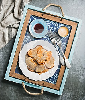 Breakfast tray with whole grain pancakes, raspberry jam, coffee espresso