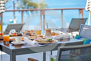 Breakfast in tropical hotel with sea view. Buffet food in restaurant in resort