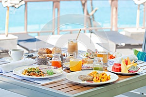 Breakfast in tropical hotel with sea view. Buffet food in restaurant in resort