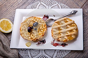 Breakfast for two, lemon tarte and tea on wooden table