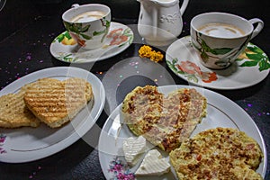 Breakfast on Valentine`s Day - fried omelete, bread, apple and White cheese in the shape of a heart coffe and milk.