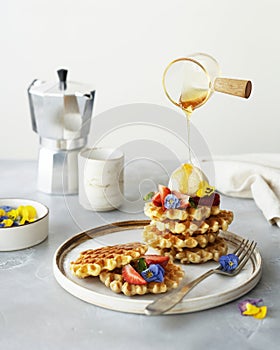 breakfast with waffles, strawberries, ice cream scoop and honey