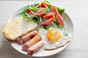 Breakfast which includes eggs, sausages, salad and toast