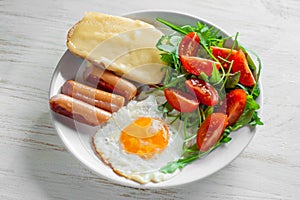 Breakfast which includes eggs, sausages, salad and toast
