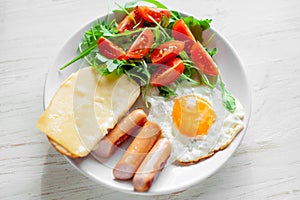 Breakfast which includes eggs, sausages, salad and toast