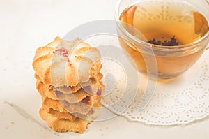 Breakfast whith cookies and glass cup whith tea/Breakfast whith cookies and glass cup whith tea on a white background. Focus on