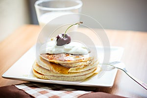 Breakfast whole wheat pancakes with cherry and yogurt