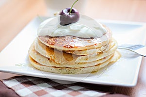 Breakfast whole wheat pancakes with cherry and yogurt