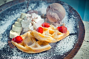 Breakfast with wholegrain brussels waffles and whipped cream, redberries