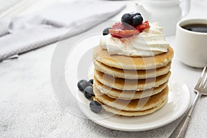 Breakfast wih Pancakes, cream, berry and coffee cup isolated on white background, copy space for text