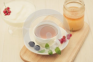 Breakfast from yogurt with berries, tea and honey/breakfast from