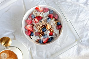 Breakfast yogurt and granola bowl topped with berries