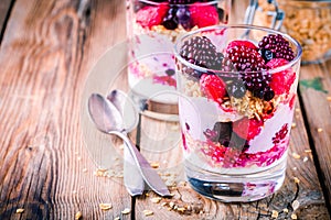 Breakfast: yogurt parfait with granola and raspberry, blueberry, banana and frozen blackberry