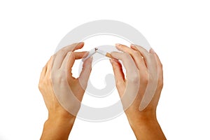 Breaking the cigarette in half