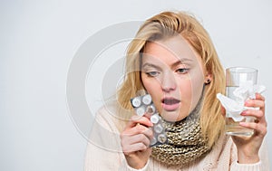 Breaking fever concept. Headache and fever remedies. Woman sick person hold glass water and tablets blister. Take pills